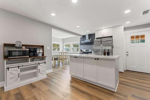 a kitchen with white cabinets and a counter top at Coastal Casa -Charming 3 Bedroom House in Gulfport