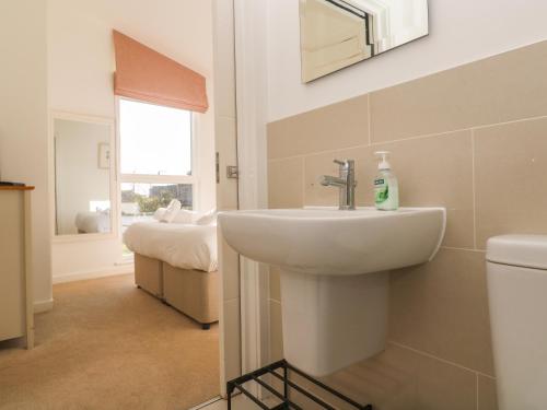 a bathroom with a sink and a toilet at Una, Lodge 77 in St Ives