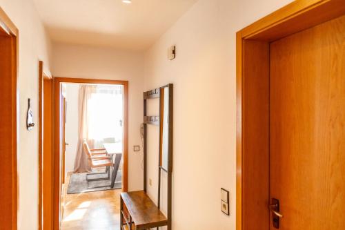 a hallway with a door and a room with chairs at APARTMENT an den Weinbergen in Iphofen