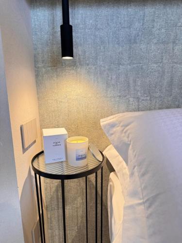 a bed with two candles on a table next to a bed at Relais La Colombaia in Appignano