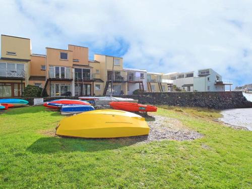 a group of boats sitting on the grass near a building at 56C South Snowdon Wharf in Porthmadog