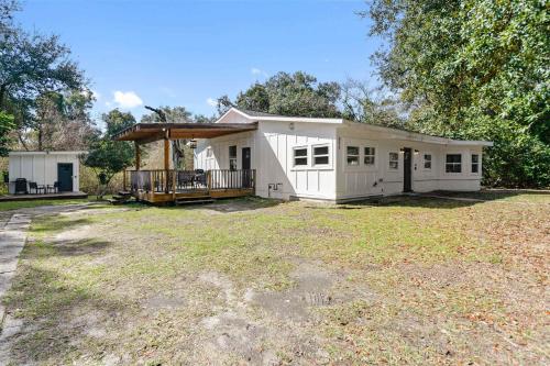 a small white house with a large yard at Coastal Cabana Studio - Close to beach and Mississippi City in Gulfport