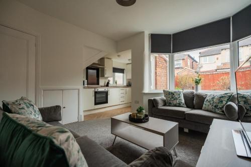 a living room with a couch and a table at Buckingham House Horizon Stays in Redcar