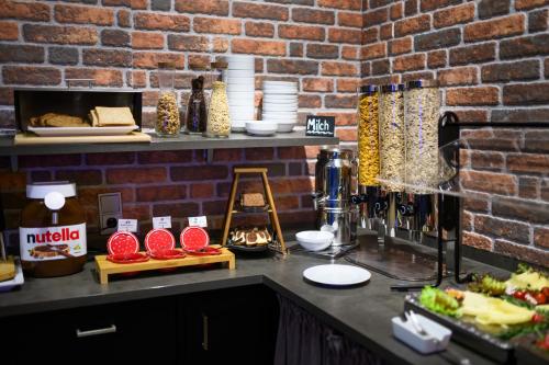 a counter with food and a brick wall at Hotel Ambassador Essen in Essen