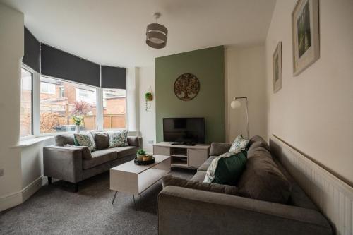 a living room with two couches and a television at Buckingham House Horizon Stays in Redcar