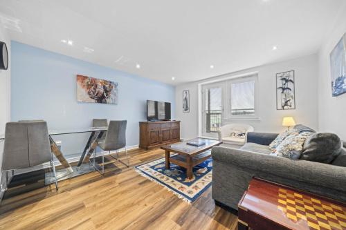 a living room with a couch and a table at Slateford 2 Bedroom Apartment - Edinburgh in Edinburgh