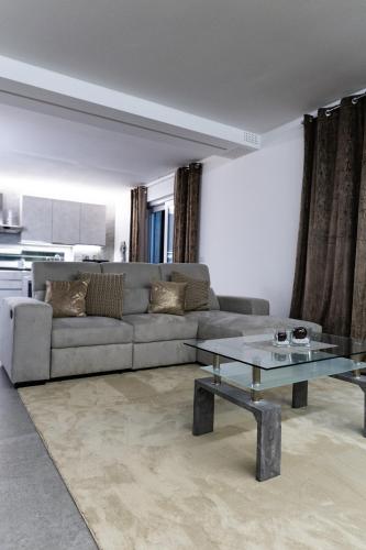 a living room with a couch and a glass table at Villa Margares in Valenzano