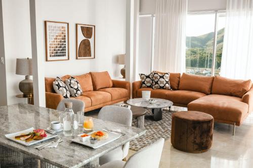 a living room with a couch and a table at Cofresi Hills Residence in Gurapito