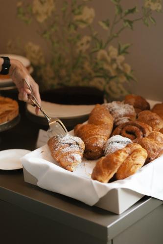 a tray of doughnuts and pastries on a table at Hotel Miramare in Civitanova Marche