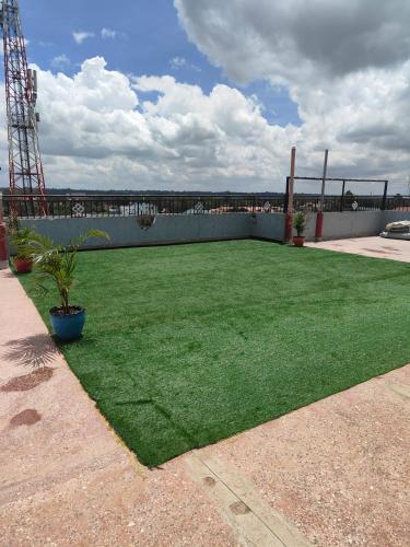 a large yard with green grass and a fence at SpringStone executive apartment in Ongata Rongai 