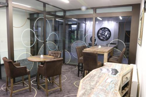 a restaurant with tables and chairs in a room at Apartment Hotel Orion in Abertamy