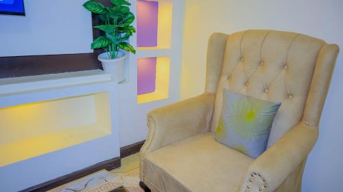 a chair with a pillow in a living room at SpringStone executive apartment in Ongata Rongai 