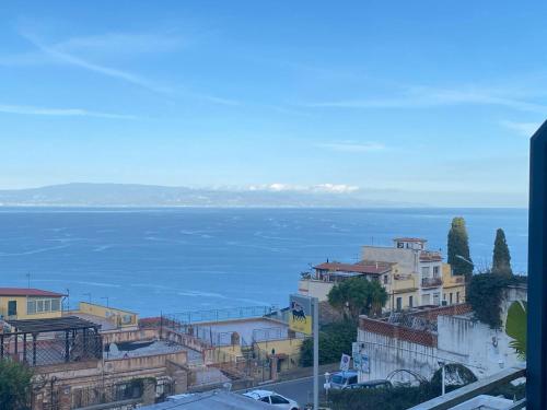 a view of a city with the ocean in the background at TaorminaCentre Panorama in Taormina