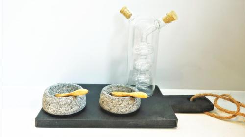 two rocks with a vase on top of a table at Spacious & Elegant Apartments in Southbank near London Eye in London
