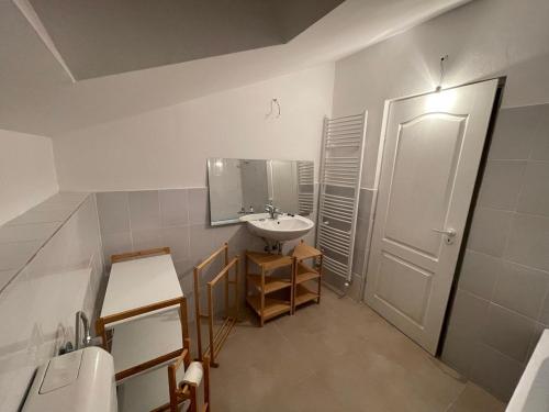 a bathroom with a sink and a mirror at Glam One Bedroom Duplex in Vila in city centre in Arad