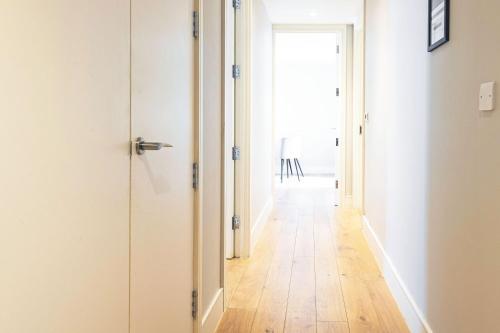 a hallway with a door leading into a room at Spacious & Elegant Apartments in Southbank near London Eye in London