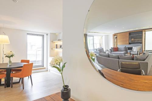 a living room with a mirror on the wall at Spacious & Elegant Apartments in Southbank near London Eye in London