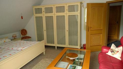 a bedroom with a bed and a coffee table at Biker-Stop in Lathen