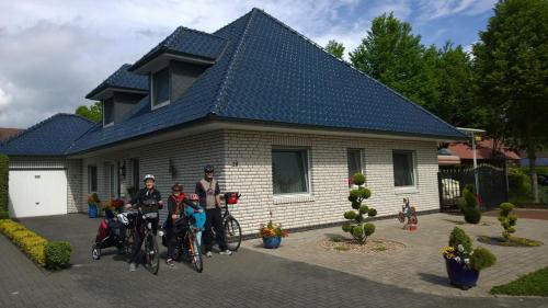 a group of people standing in front of a house at Biker-Stop in Lathen
