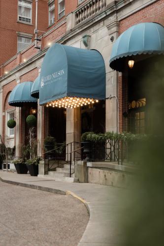 a building with a blue awning with lights on it at The Lord Nelson Hotel & Suites in Halifax