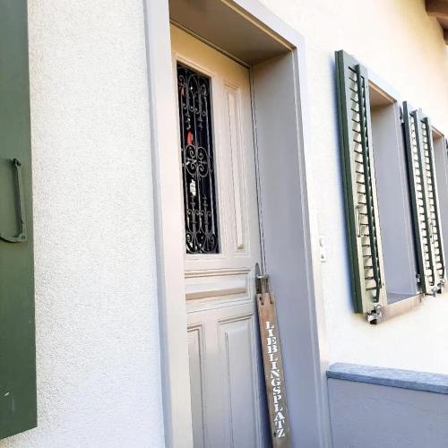 a white door with a wrought iron grate on it at Kaffeegasse 11 - Holiday home with heart on Lake Constance in Altnau