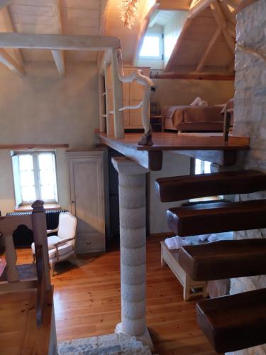 a room with a loft with a staircase and a bed at Artsistas Houses in Aristi