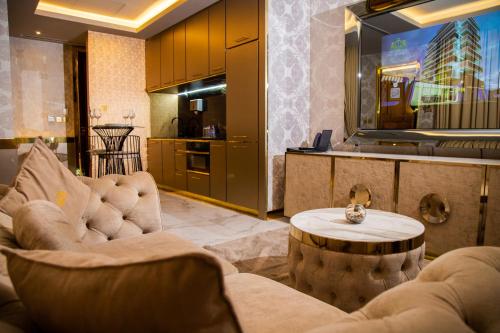 a living room with two couches and a table at Number One Oxford Street Hotel & Suites in Accra