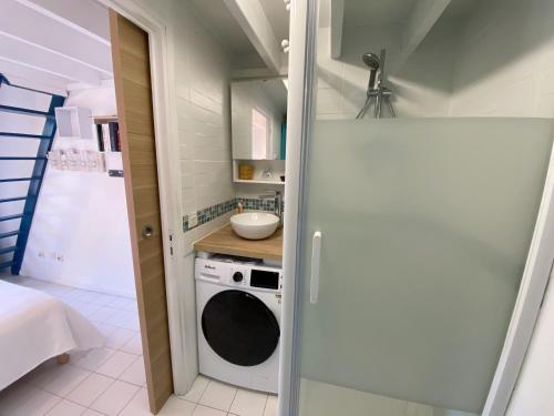 une petite cuisine avec une machine à laver et un évier dans l'établissement CALLEA 2 - Maison de vacances avec jardin Carnac - K16, à Carnac