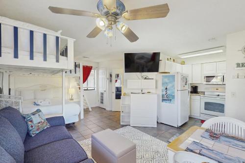 a living room with a couch and a ceiling fan at Paradise Cove in Panama City Beach