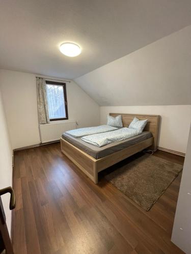 a bedroom with a bed and a window at Casa Sofia in Băile Homorod