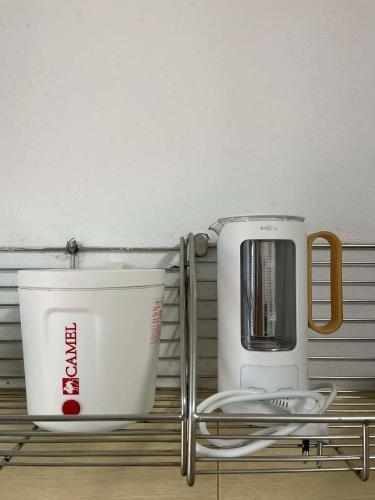 two appliances sitting on a shelf in a kitchen at The Cozy Lazy Home Hatyai in Hat Yai