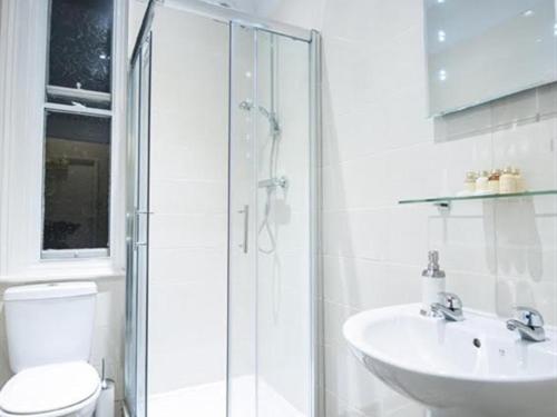 a bathroom with a shower and a toilet and a sink at Parkwood Hotel in Stockton-on-Tees