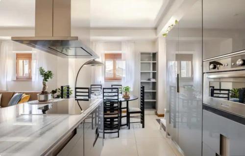 a kitchen with a counter and a table and chairs at Piazza Brà - refined 130 sqm with 2 suites in Verona