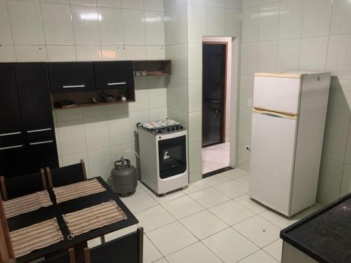 a kitchen with a refrigerator and a stove at Casa in Cabo Frio