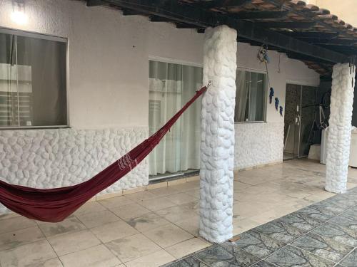 a hammock in the middle of a building with columns at Casa in Cabo Frio