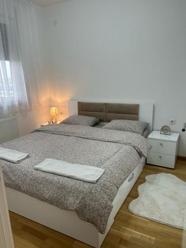 a bedroom with a bed with two towels on it at Apartman NS FREE PARKING in Novi Sad