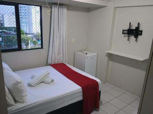 a bedroom with a bed with a red and white blanket at Apto 2/4 Centro Recife in Recife