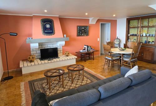 a living room with a couch and a fireplace at HOME4U in Horta