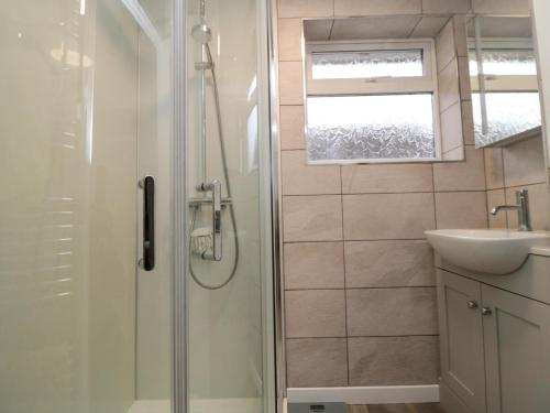 a bathroom with a shower and a sink at Sycamore in Filey
