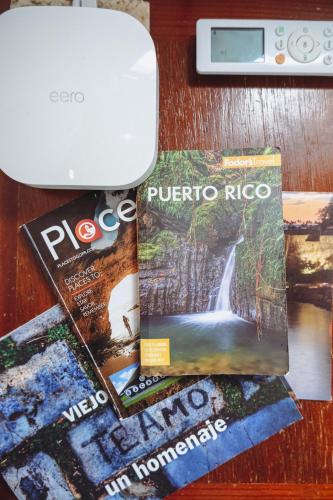 a table with two magazines and a printer on it at Caribe Rentals in San Juan
