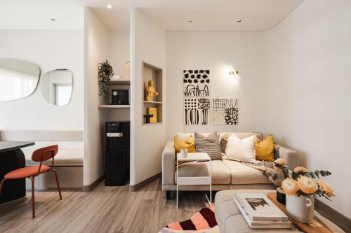 a living room with a couch and a table at 2BR Cozy City View CBD Sudirman Park Apartment, Luxury & Chic Design in Jakarta