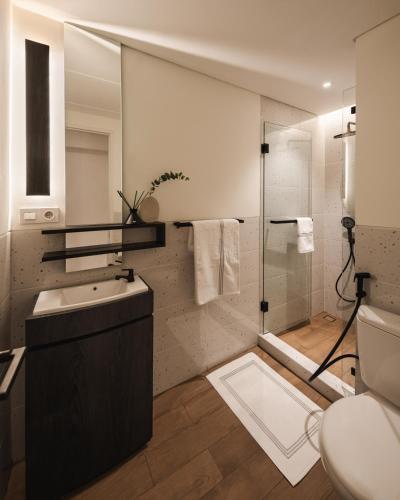 a bathroom with a shower and a sink and a toilet at 2BR Cozy City View CBD Sudirman Park Apartment, Luxury & Chic Design in Jakarta