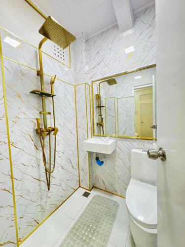 a bathroom with a toilet and a sink at Ontrack Travel Transit Hotel in Male City
