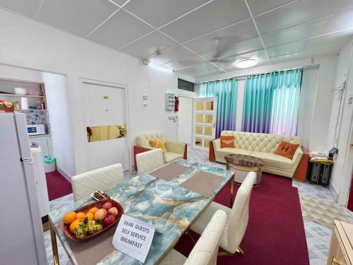 a room with a dining table and a living room at Ontrack Travel Transit Hotel in Male City