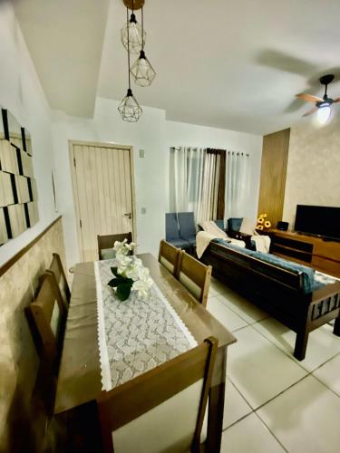 a living room with a table and a couch at Casa em Condomínio em Mangaratiba in Mangaratiba