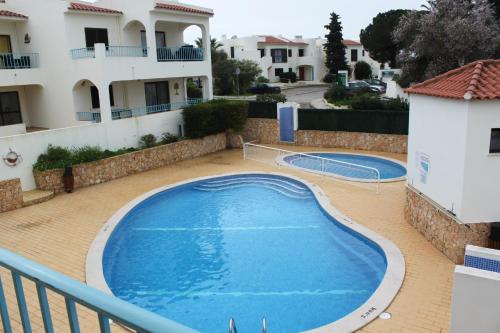 a swimming pool on a balcony of a house at Apartamento Morning Cascade in Carvoeiro