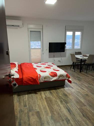 a bedroom with a bed and a table with chairs at Mimura stan 2 in Belgrade