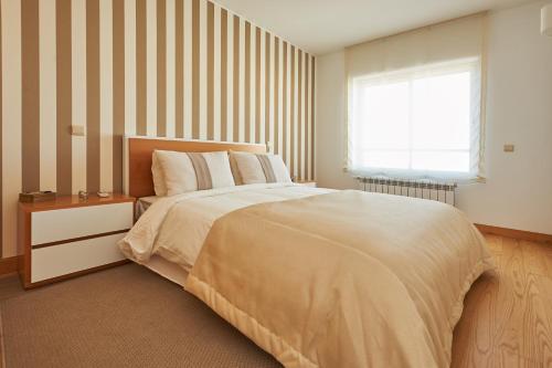Ένα ή περισσότερα κρεβάτια σε δωμάτιο στο BeGuest Premium Lisbon Suites