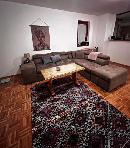 a living room with a couch and a coffee table at Comfort&Peace in Sarajevo