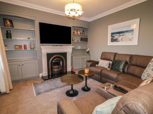 a living room with a couch and a fireplace at Gweedore Homestead in Letterkenny